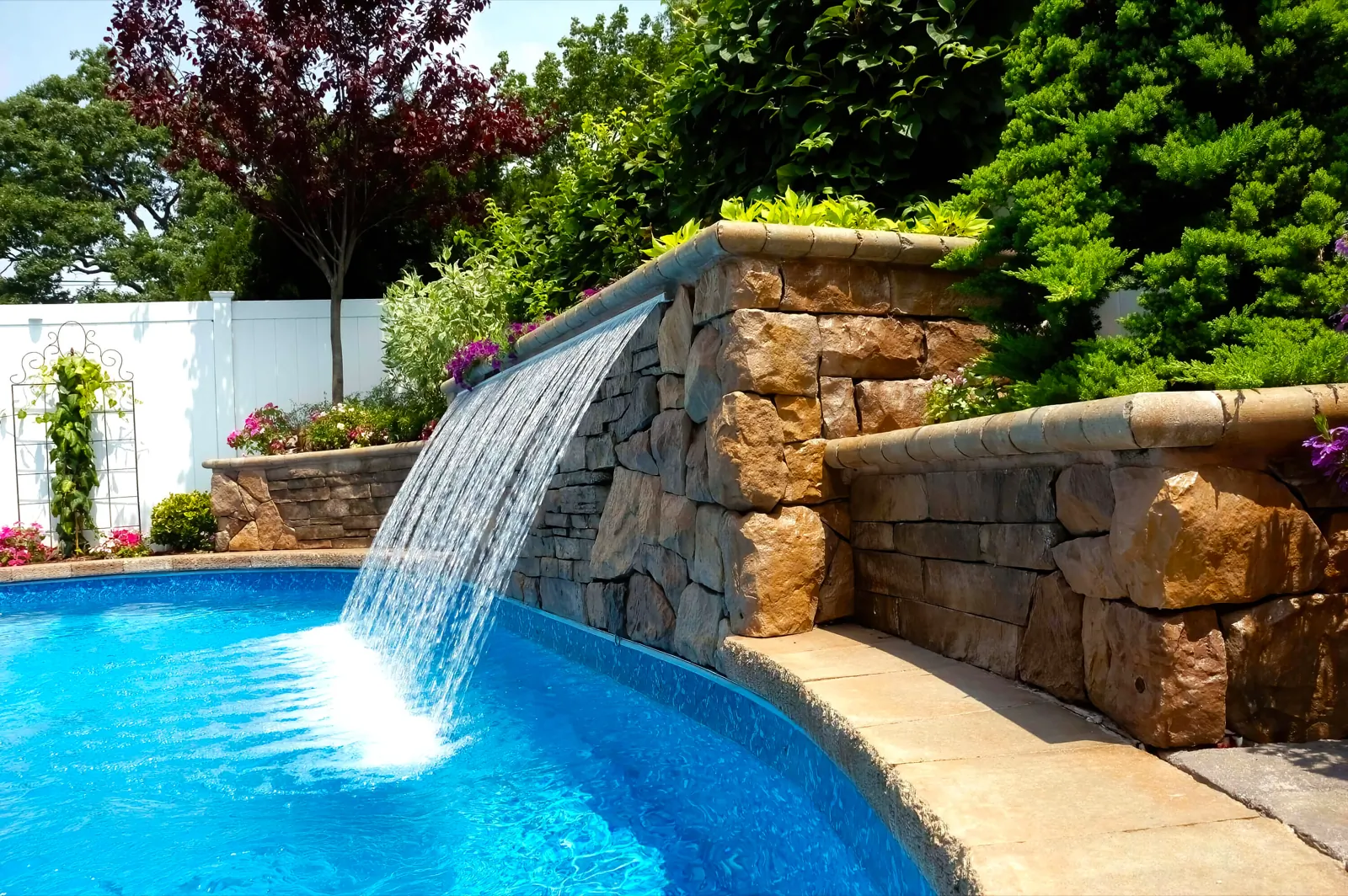 Stone waterfall feature spilling into a pool